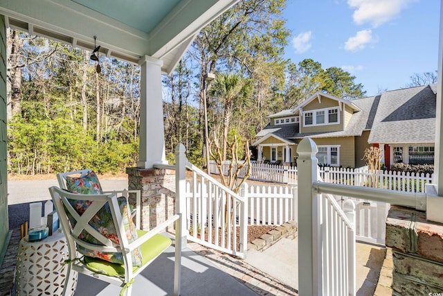 view of patio featuring covered porch and a fenced front yard