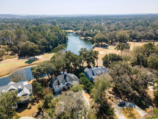 aerial view featuring a forest view and a water view