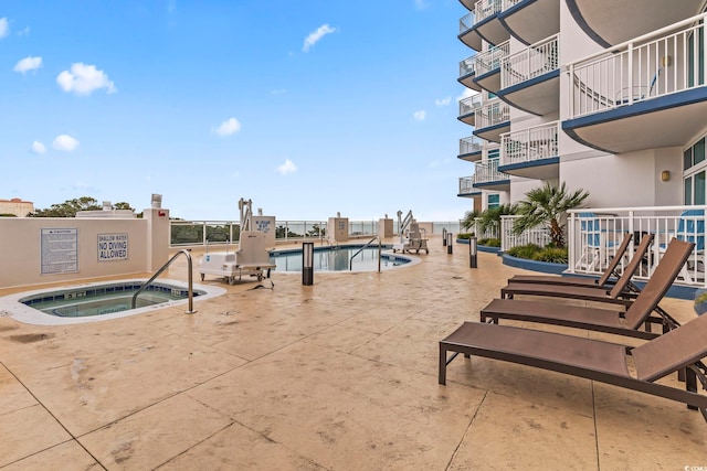 exterior space featuring a community hot tub and a community pool