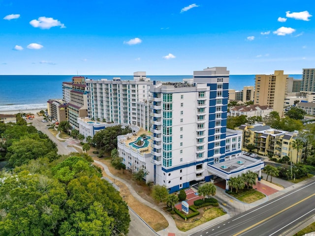 birds eye view of property with a water view and a city view