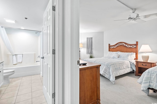 bedroom with ceiling fan, ensuite bathroom, and light tile patterned floors