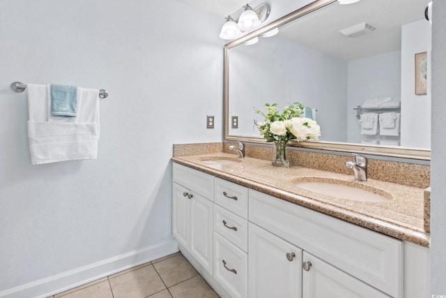 full bath featuring double vanity, a sink, visible vents, and tile patterned floors