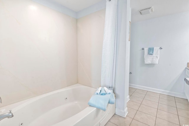 full bathroom with a jetted tub, tile patterned flooring, visible vents, and baseboards