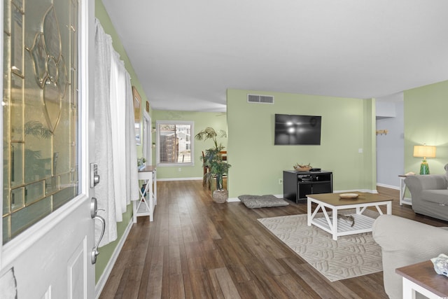 interior space with dark wood finished floors, baseboards, and visible vents