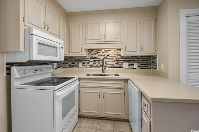 kitchen with tasteful backsplash, white appliances, light countertops, and a sink