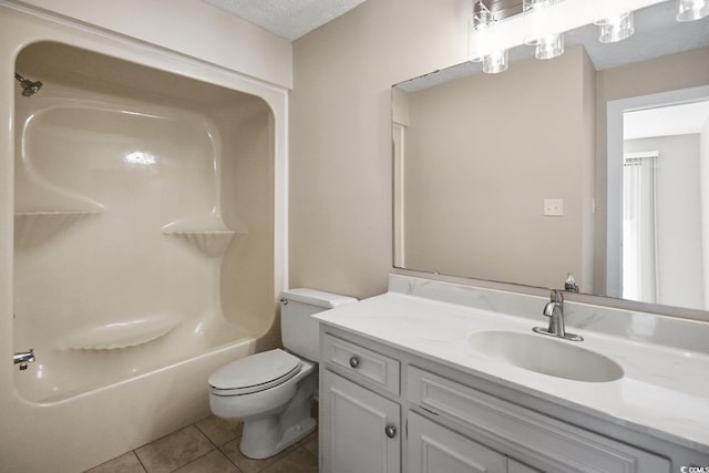 bathroom featuring a textured ceiling, bathtub / shower combination, toilet, vanity, and tile patterned floors