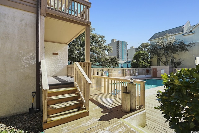 wooden deck featuring a fenced in pool