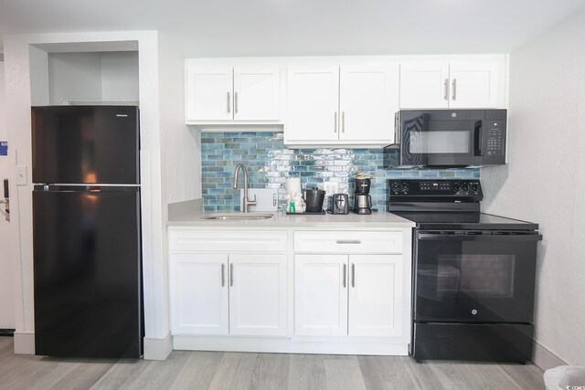 2401 S Ocean Blvd Unit 971, Myrtle Beach, SC 29577 - kitchen featuring a sink, light wood-type flooring, black appliances, and white cabinets