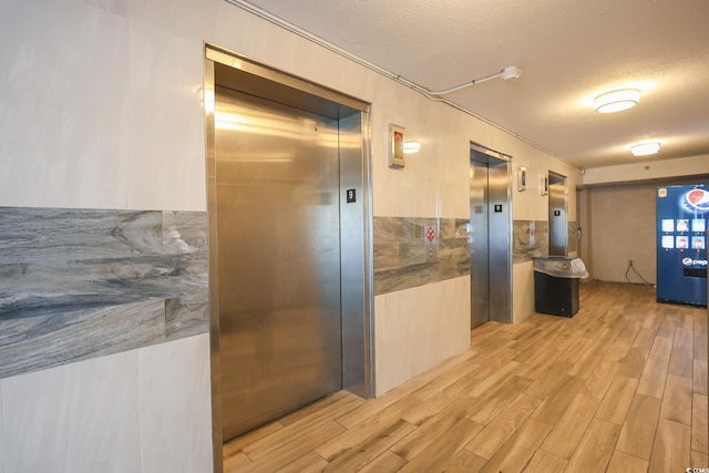 2401 S Ocean Blvd Unit 971, Myrtle Beach, SC 29577 - hall with elevator, light wood-style floors, and a textured ceiling