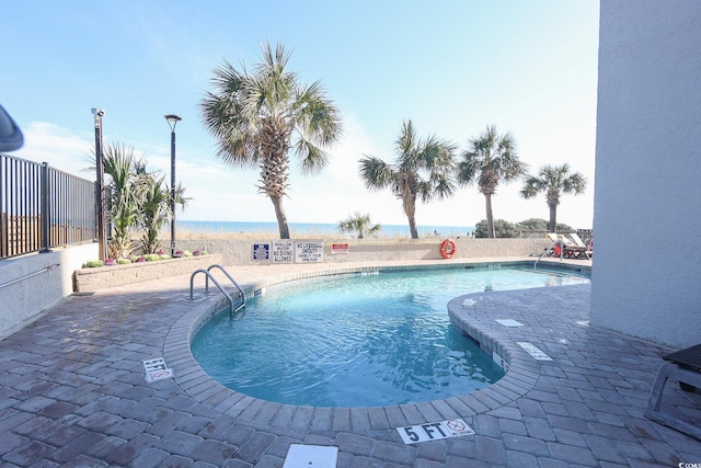 2401 S Ocean Blvd Unit 971, Myrtle Beach, SC 29577 - community pool featuring a patio area, a water view, and fence