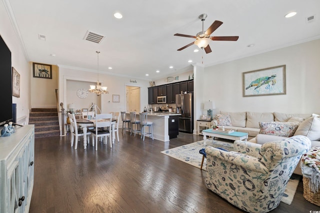 living area featuring dark wood-style floors, stairway, visible vents, and crown molding