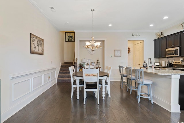 dining space with ornamental molding, dark wood-style flooring, stairway, and an inviting chandelier