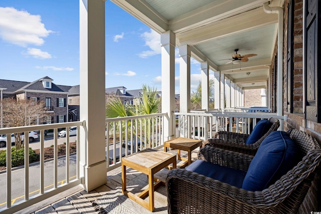 balcony with a residential view and a ceiling fan