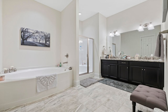 full bathroom featuring double vanity, a sink, a shower stall, and a bath