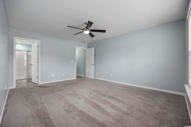 unfurnished bedroom with connected bathroom, carpet flooring, ceiling fan, and baseboards