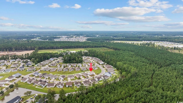 birds eye view of property featuring a residential view and a wooded view