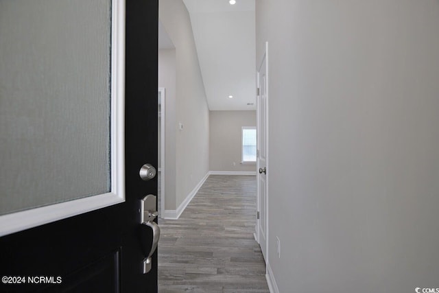 hall with baseboards, wood finished floors, and recessed lighting