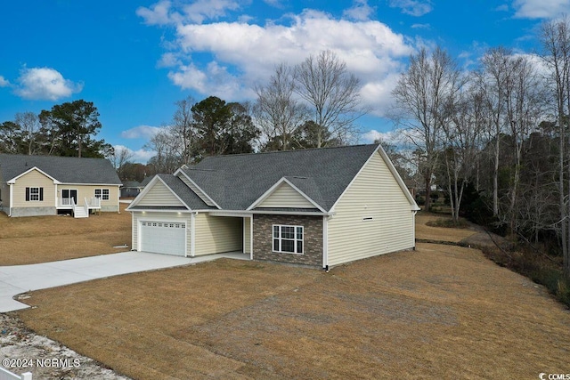 view of front of home featuring stone siding, driveway, a front lawn, and an attached garage