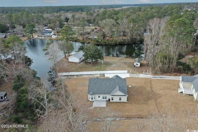 drone / aerial view with a water view and a wooded view