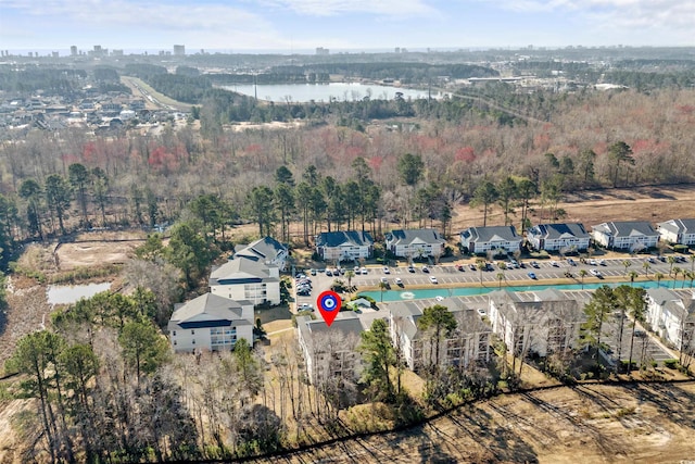 bird's eye view with a wooded view