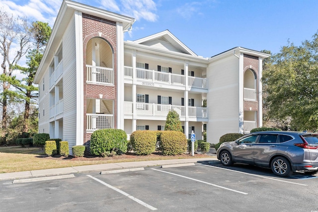 view of building exterior with uncovered parking