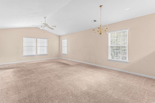 carpeted empty room with ceiling fan with notable chandelier, baseboards, vaulted ceiling, and visible vents