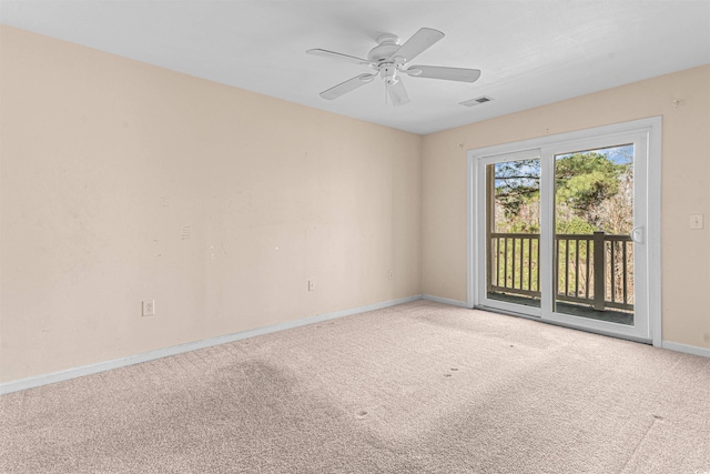 carpeted spare room with a ceiling fan, baseboards, and visible vents