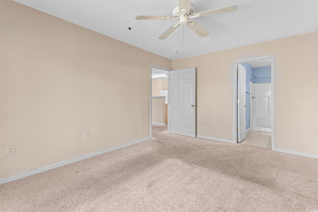 unfurnished bedroom featuring a ceiling fan, ensuite bath, baseboards, and light colored carpet