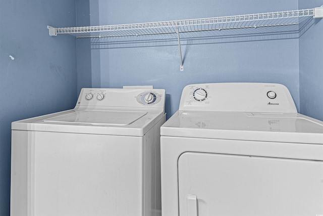 washroom with washing machine and clothes dryer and laundry area