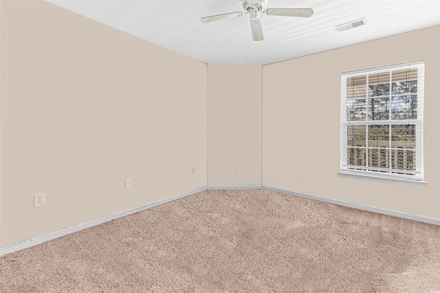 unfurnished room with baseboards, carpet flooring, ceiling fan, and visible vents