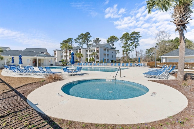 pool featuring fence and a patio area