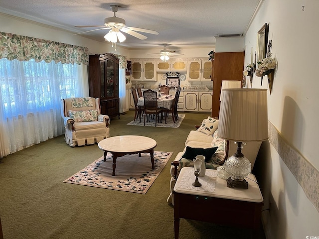 living area featuring a textured ceiling, carpet floors, visible vents, and crown molding