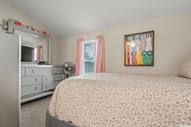 bedroom with dark carpet, vaulted ceiling, and a textured ceiling