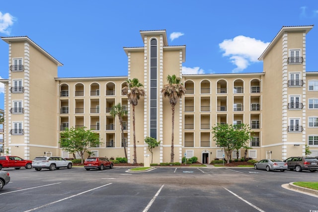 view of property featuring uncovered parking