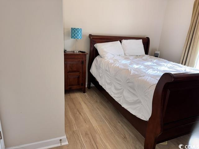 6253 Catalina Dr Unit 921, North Myrtle Beach, SC 29582 - bedroom featuring light wood-type flooring and baseboards