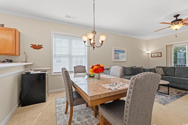 dining room with baseboards, visible vents, ornamental molding, and light colored carpet