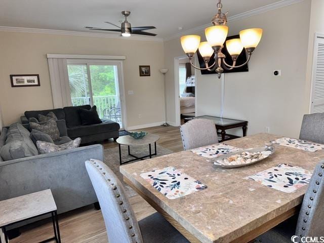 6253 Catalina Dr Unit 921, North Myrtle Beach, SC 29582 - dining room featuring light wood finished floors, ceiling fan, ornamental molding, a chandelier, and baseboards