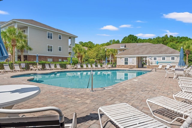 pool with fence and a patio