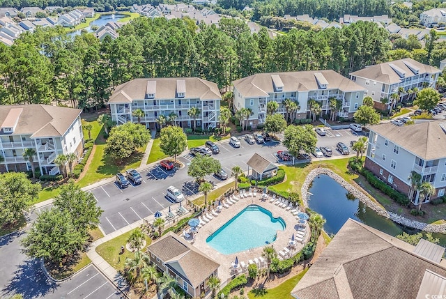 drone / aerial view featuring a residential view and a water view