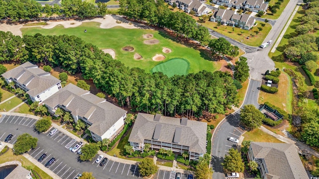 drone / aerial view with view of golf course and a residential view