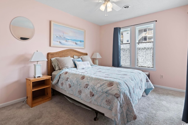 bedroom featuring carpet flooring, ceiling fan, visible vents, and baseboards