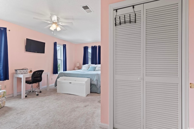 bedroom with carpet, a closet, visible vents, and baseboards