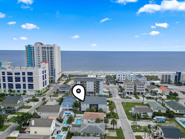 birds eye view of property with a water view and a city view