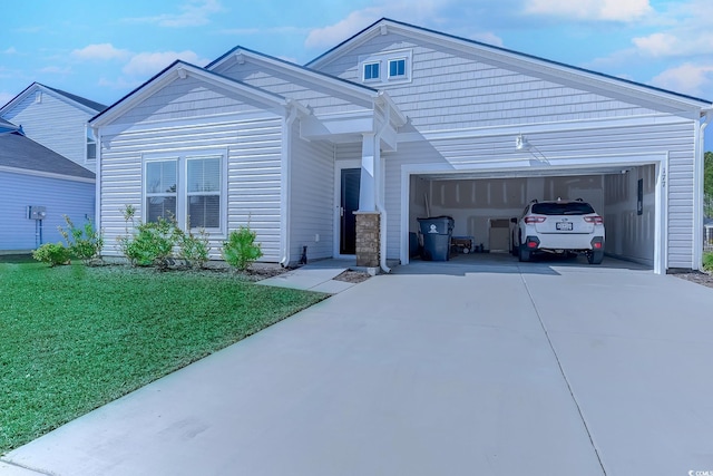 view of front of house featuring a garage, a front lawn, and concrete driveway