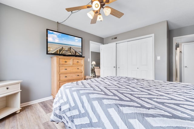 3308 S Ocean Blvd Unit 2-A, North Myrtle Beach, SC 29582 - bedroom with light wood-style floors, a closet, baseboards, and a ceiling fan