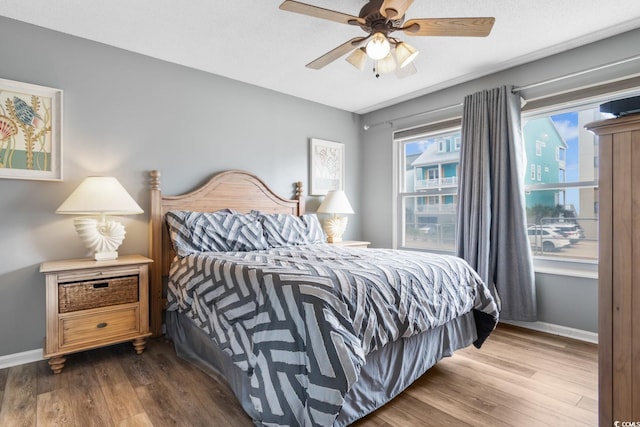 3308 S Ocean Blvd Unit 2-A, North Myrtle Beach, SC 29582 - bedroom with wood finished floors, baseboards, and a ceiling fan