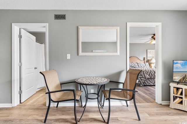 3308 S Ocean Blvd Unit 2-A, North Myrtle Beach, SC 29582 - dining space featuring light wood finished floors, ceiling fan, and baseboards