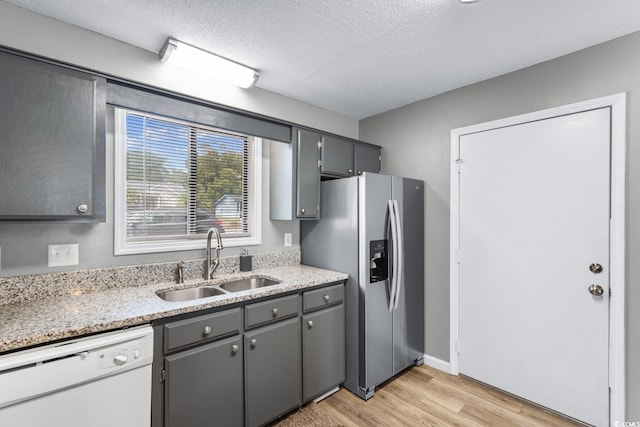 3308 S Ocean Blvd Unit 2-A, North Myrtle Beach, SC 29582 - kitchen featuring white dishwasher, a sink, stainless steel fridge, gray cabinetry, and light wood-style flooring