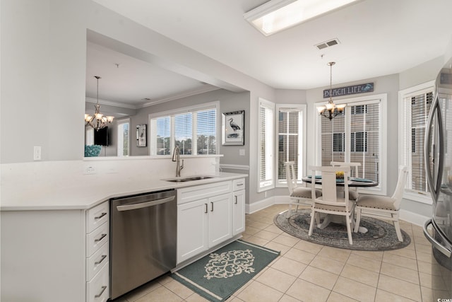 kitchen featuring stainless steel appliances, a sink, visible vents, and an inviting chandelier