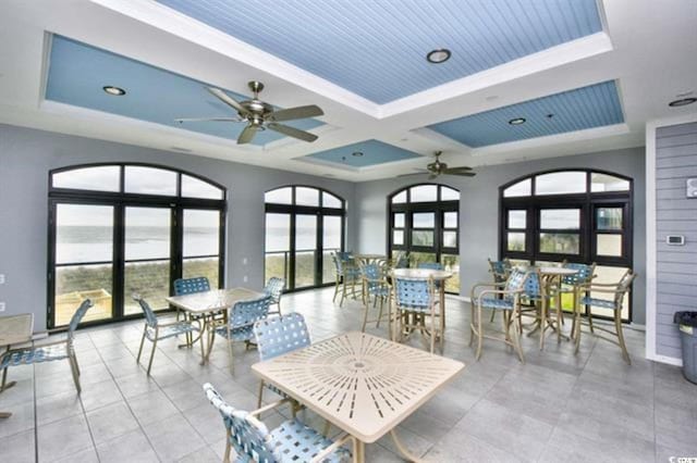 sunroom with ceiling fan and coffered ceiling